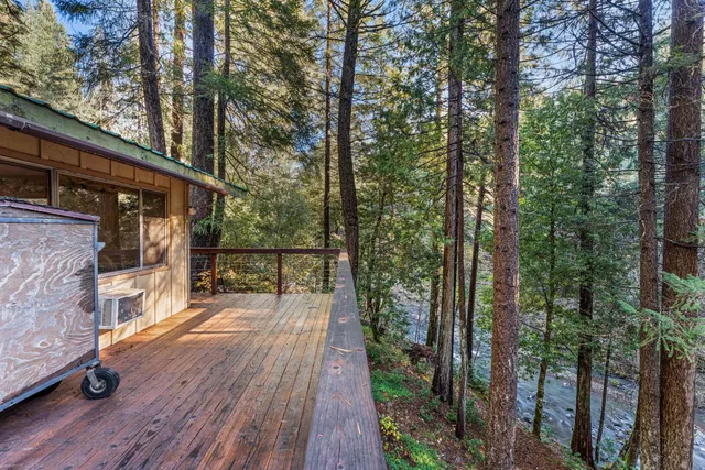a view of a balcony with wooden floor and fence