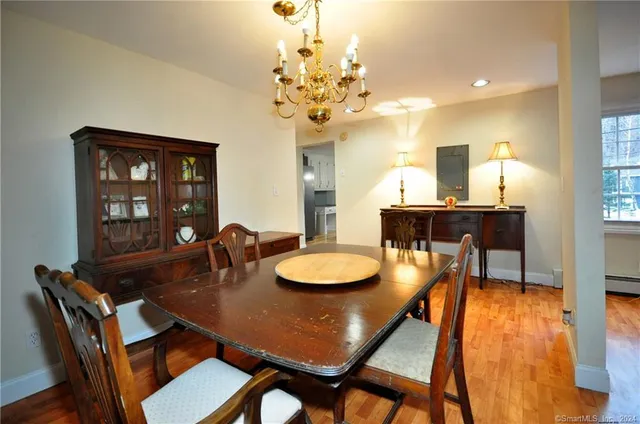a view of a dining room with furniture and chandelier