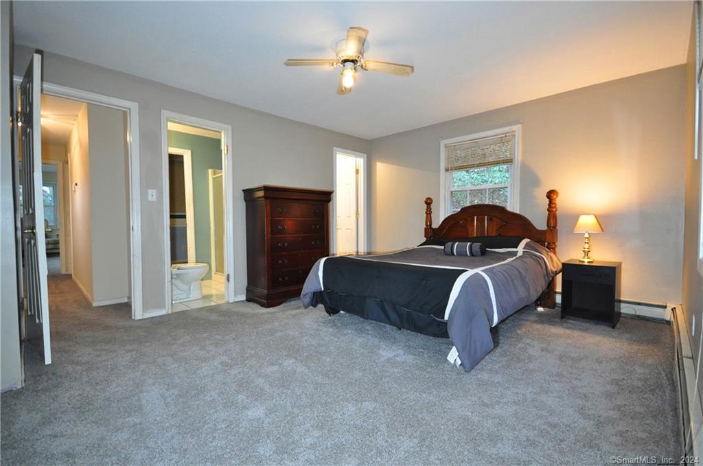45 Barkhamsted Road Granby, CT 06090 - Photo 27 of 35 a bedroom with a bed and a chandelier