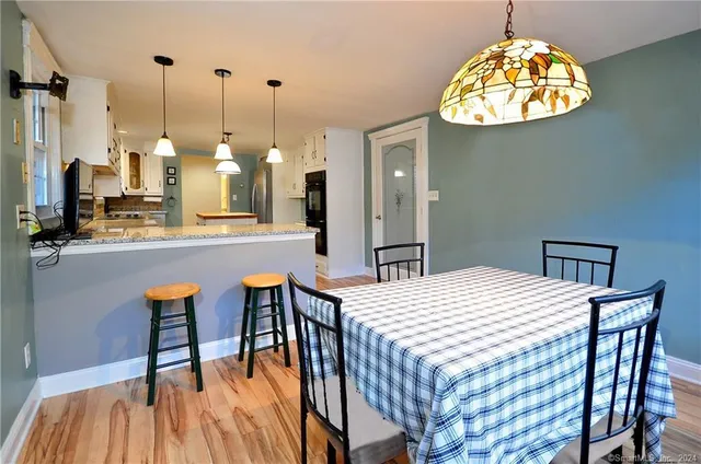 a backyard of a house with barbeque oven table and chairs