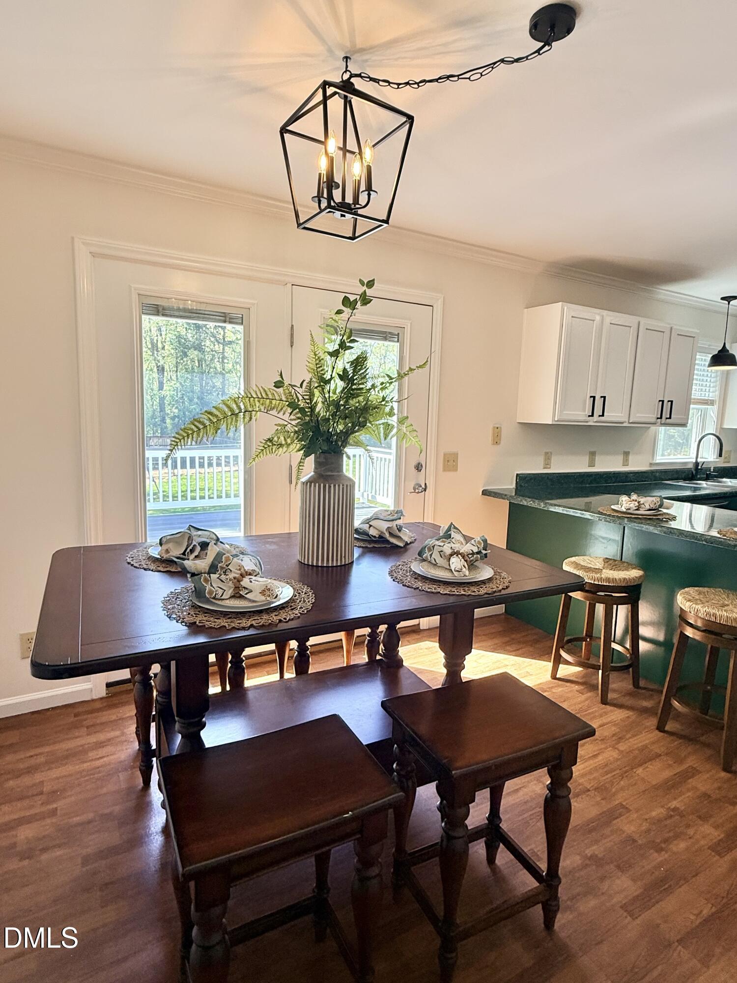 2429 Halifax Road Roxboro, NC 27573 - Photo 15 of 54 a view of a dining room with furniture window and wooden floor