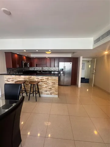a living room with furniture a window and a chandelier