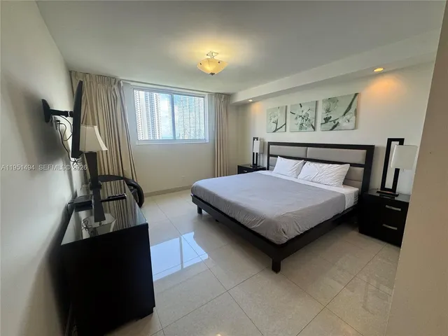 a bedroom with furniture and a window