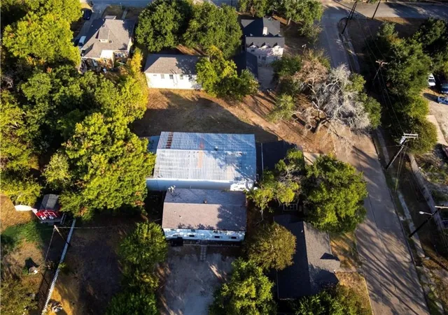an aerial view of a house with a yard