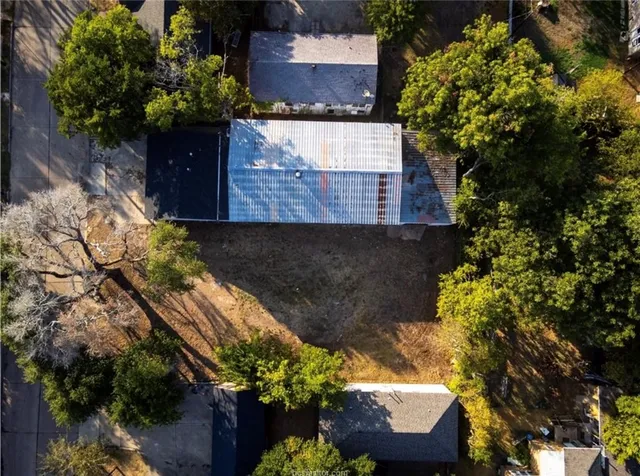 an aerial view of a house with a yard