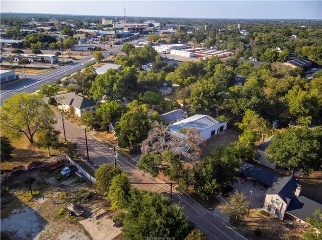 an aerial view of residential houses with outdoor space
