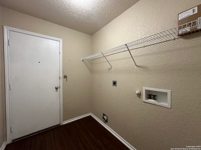 a view of a small space with wooden floor and a window