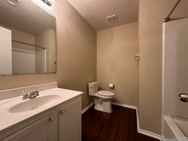 a bathroom with a sink toilet and vanity