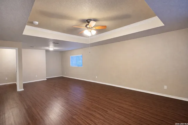 a view of an empty room with wooden floor