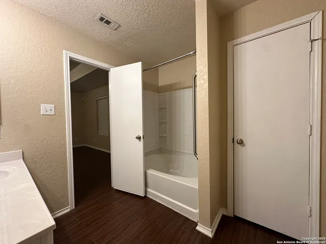 a bathroom with a bathtub and a shower