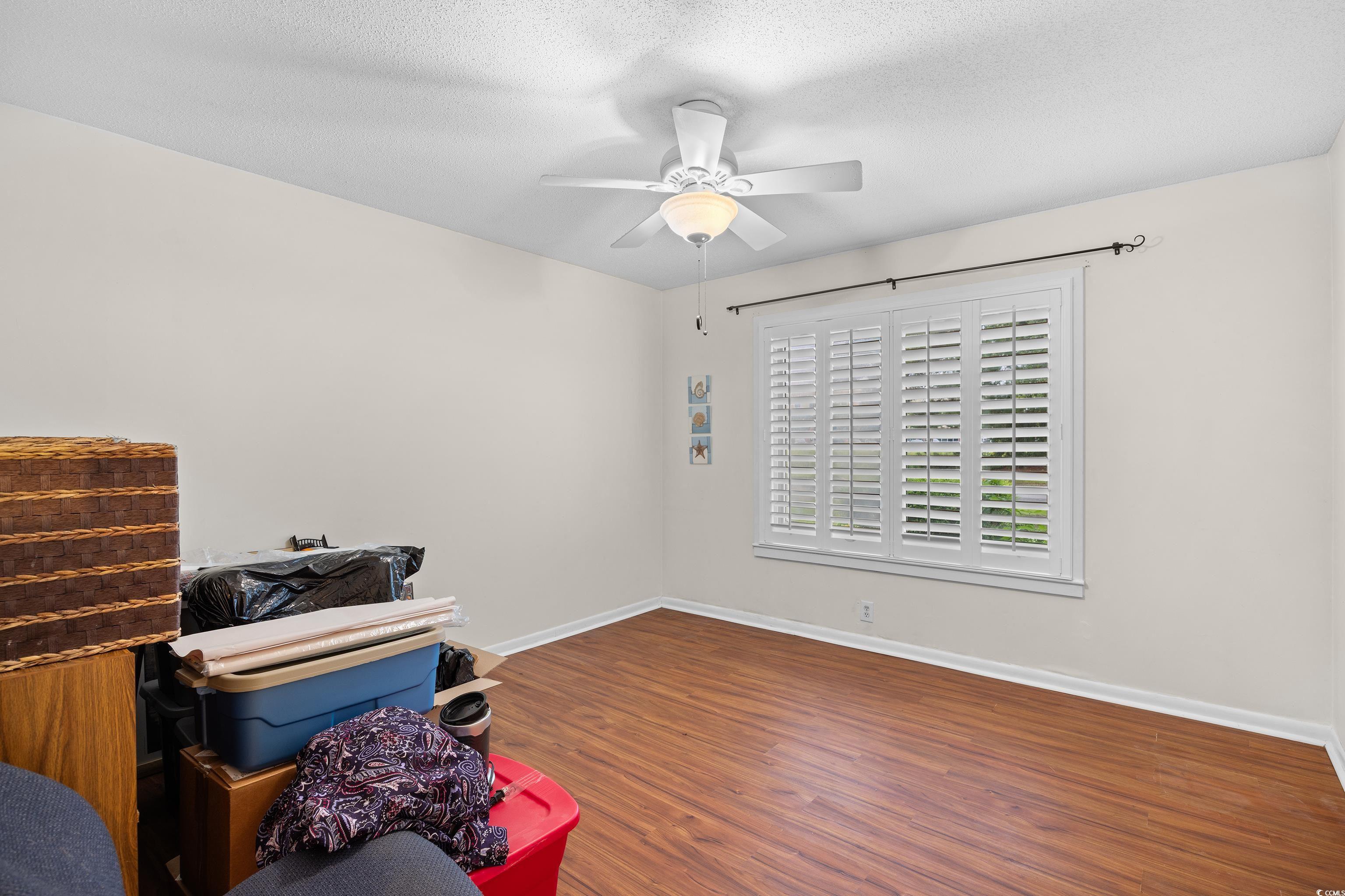 500 Eagle Way, Unit 4 Little River, SC 29566 - Photo 13 of 19 Misc room featuring dark wood finished floors, a textured ceiling, and ceiling fan