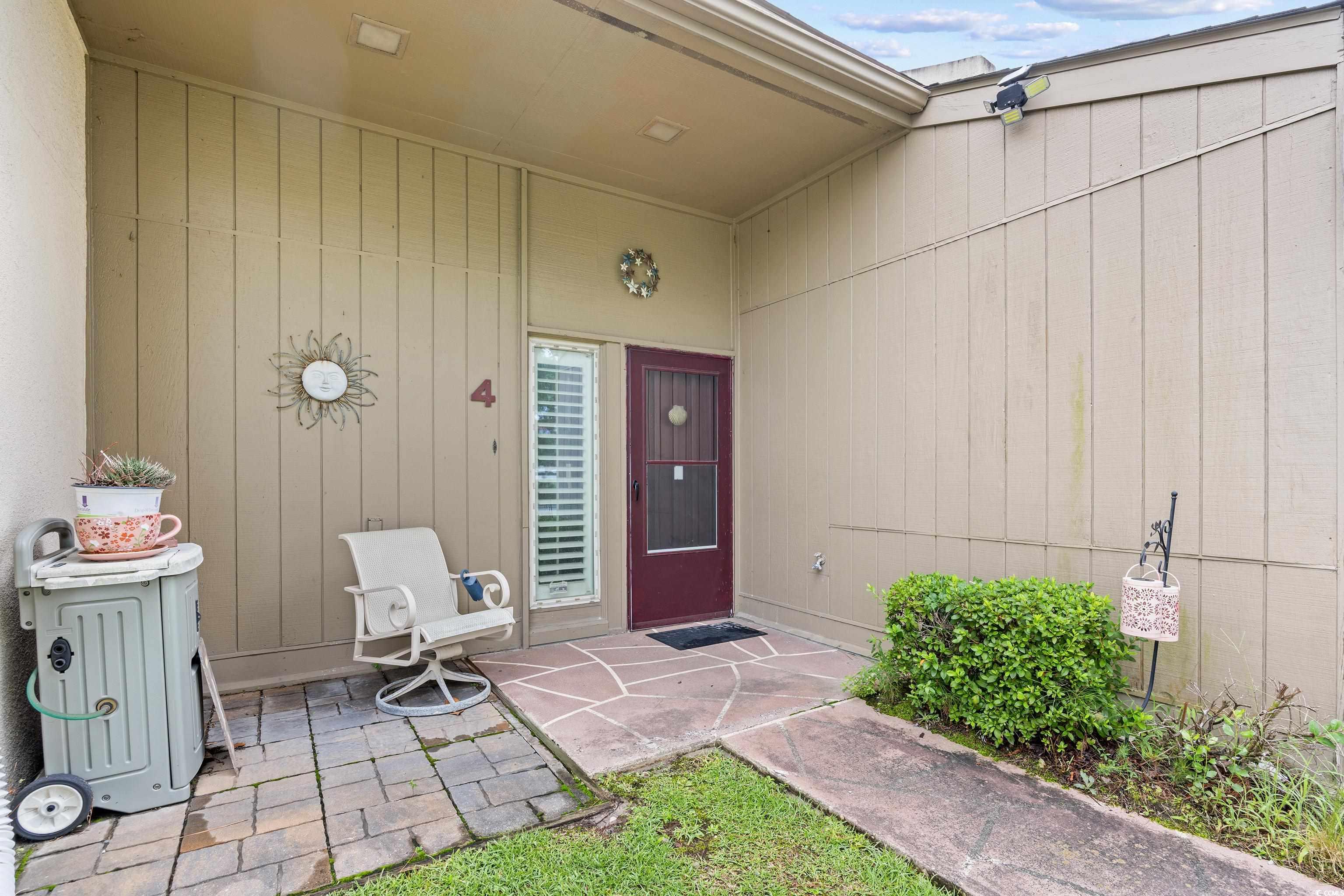 500 Eagle Way, Unit 4 Little River, SC 29566 - Photo 17 of 19 Doorway to property featuring a patio area