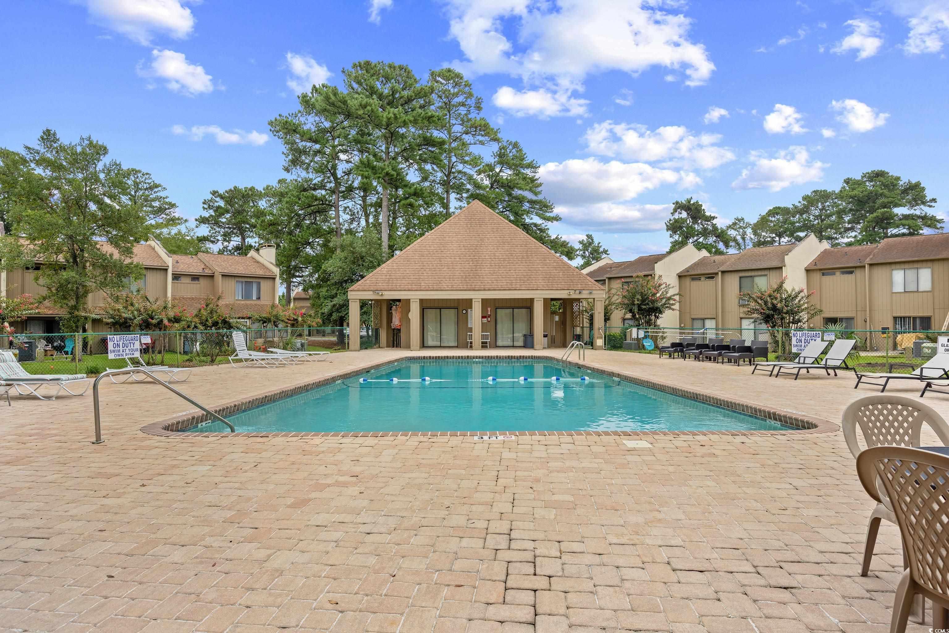 500 Eagle Way, Unit 4 Little River, SC 29566 - Photo 19 of 19 Community pool featuring a patio and a residential view