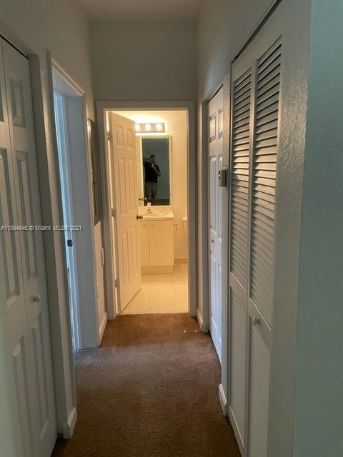 Oasis Homestead, FL 33033 - Photo 11 of 37 a view of a hallway with wooden floor and a bathroom