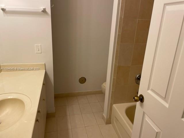 Oasis Homestead, FL 33033 - Photo 20 of 37 a bathroom with a tub a sink and a washer dryer