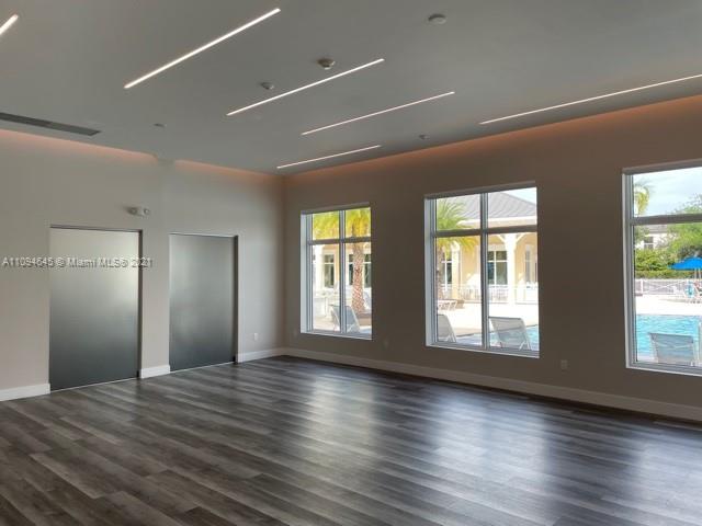 Oasis Homestead, FL 33033 - Photo 27 of 37 a view of a livingroom with wooden floor and windows