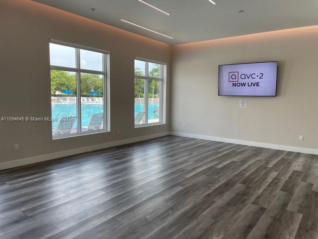 Oasis Homestead, FL 33033 - Photo 28 of 37 a view of an empty room with wooden floor and a window