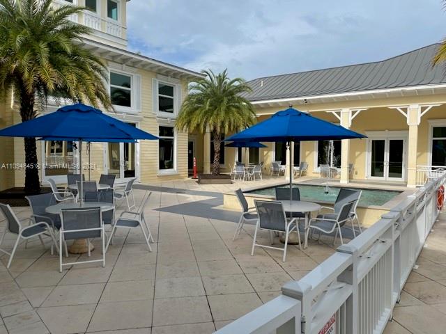 Oasis Homestead, FL 33033 - Photo 29 of 37 a patio with a table and chairs under an umbrella