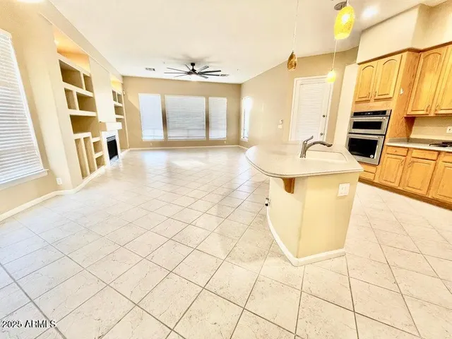 a kitchen with stainless steel appliances a stove a sink and a refrigerator with white cabinets