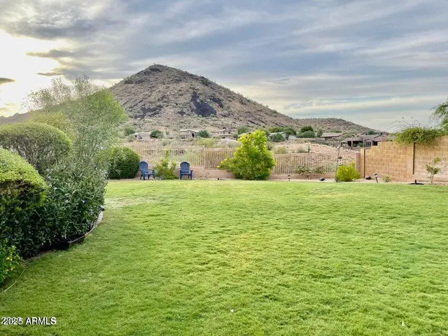 a view of a big yard with an buildings in the background