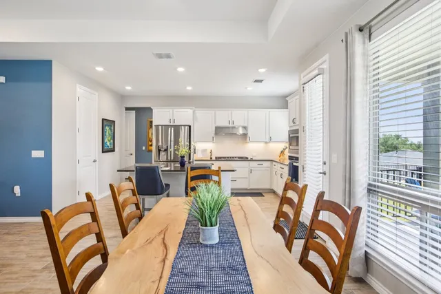 a view of a dining room with furniture kitchen and wooden floor