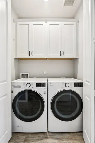 a bathroom with a sink a potted plant and a mirror