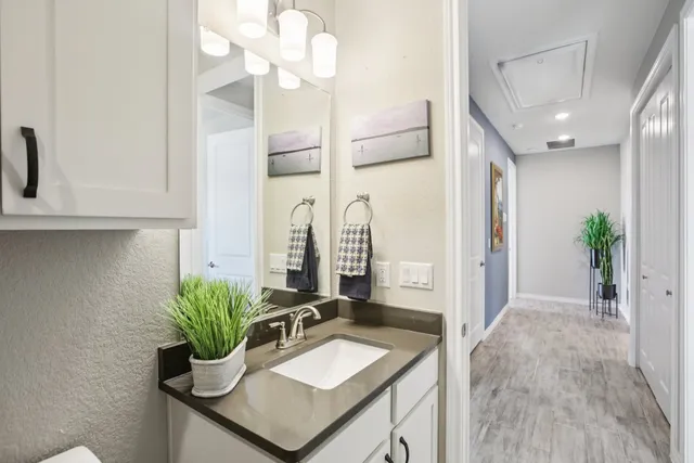 a bathroom with a sink a toilet a mirror and vanity