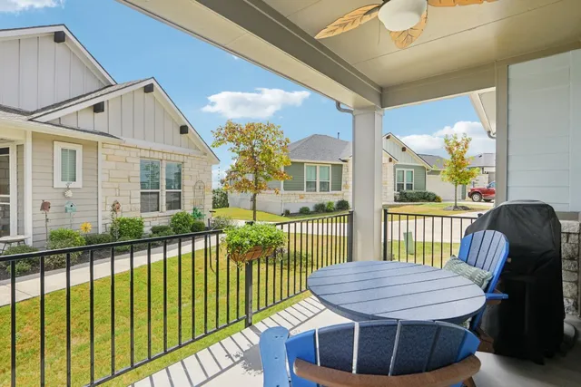 a view of a porch with furniture and a yard