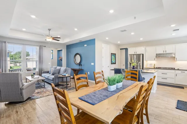 a living room with dining room and wooden floor