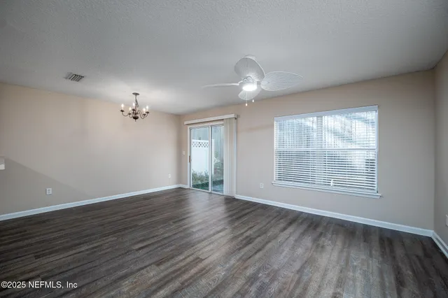 a view of a kitchen with a dishwasher a kitchen a ceiling fan and wooden floor