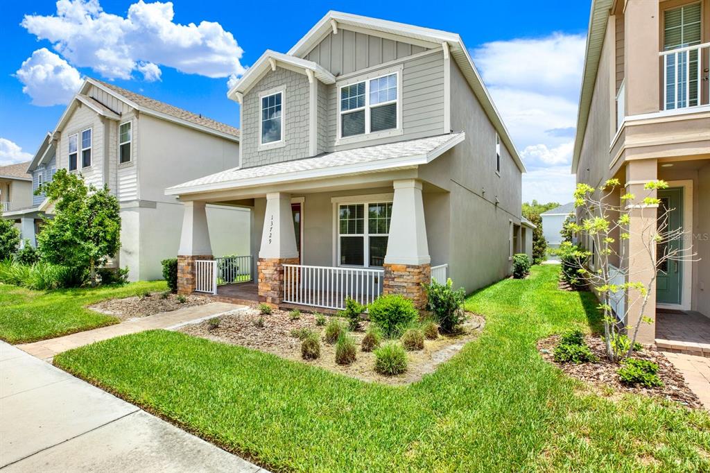 13729 Rangeland Boulevard Odessa, FL 33556 - Photo 2 of 30 a front view of a house with garden and porch