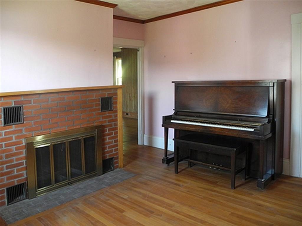 11 Cobbossee Avenue Gardiner, ME 04345 - Photo 6 of 18 Fireplace and piano in front room