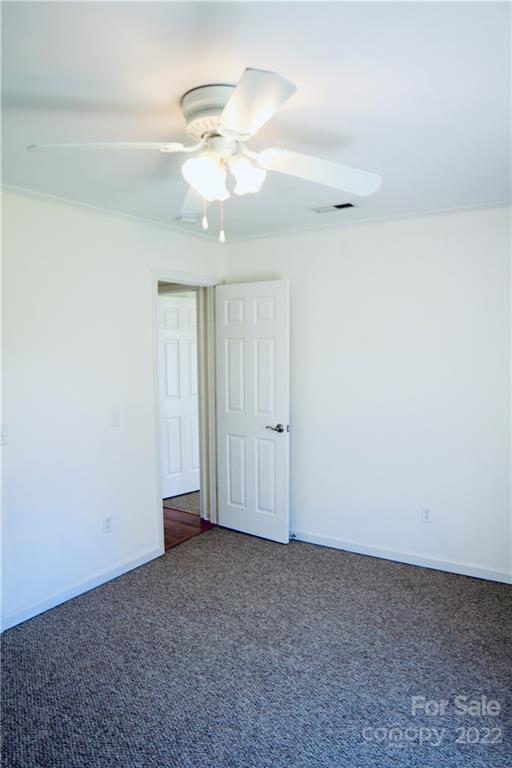 4197 Renee Ford Road Stanfield, NC 28163 - Photo 14 of 23 an empty room with a chandelier fan