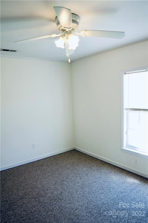 4197 Renee Ford Road Stanfield, NC 28163 - Photo 15 of 23 an empty room with a chandelier fan and window