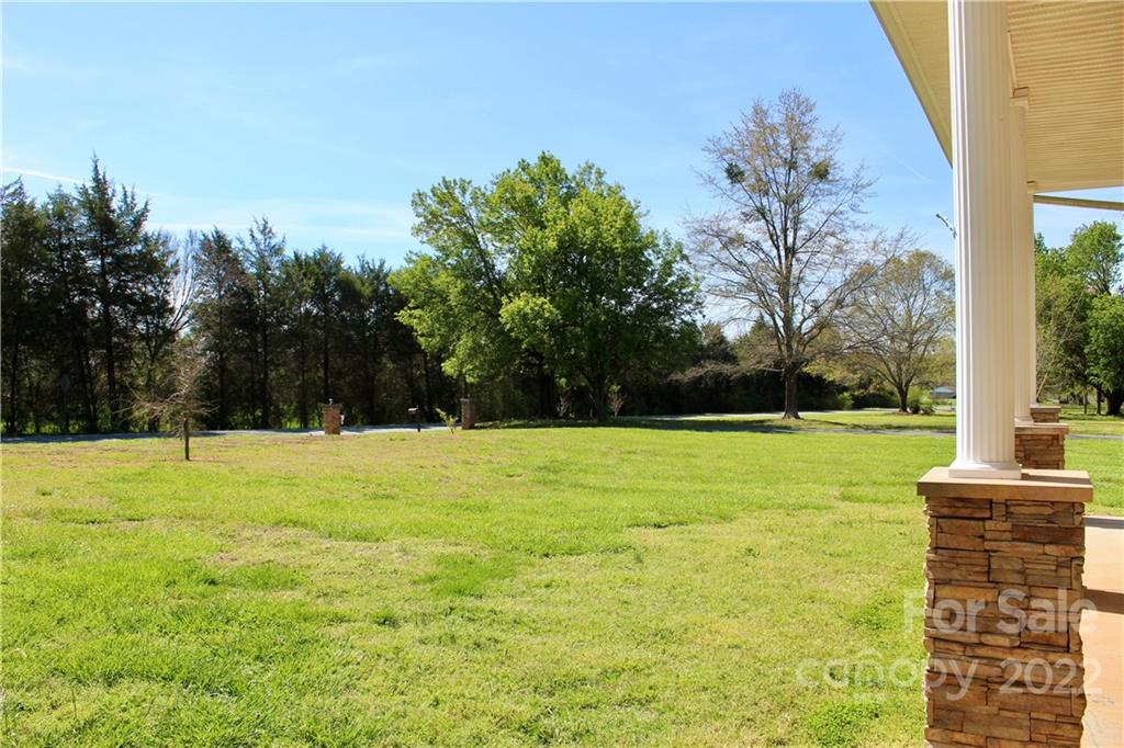 4197 Renee Ford Road Stanfield, NC 28163 - Photo 3 of 23 a view of a yard with a palm tree