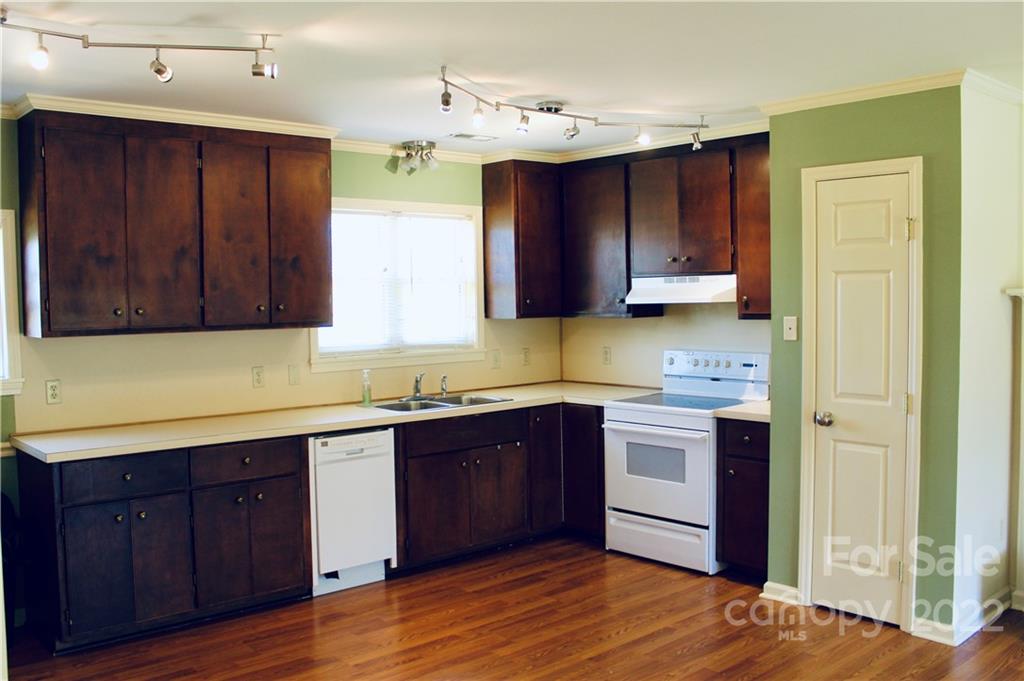 4197 Renee Ford Road Stanfield, NC 28163 - Photo 6 of 23 a kitchen with stainless steel appliances granite countertop wooden cabinets a sink and dishwasher