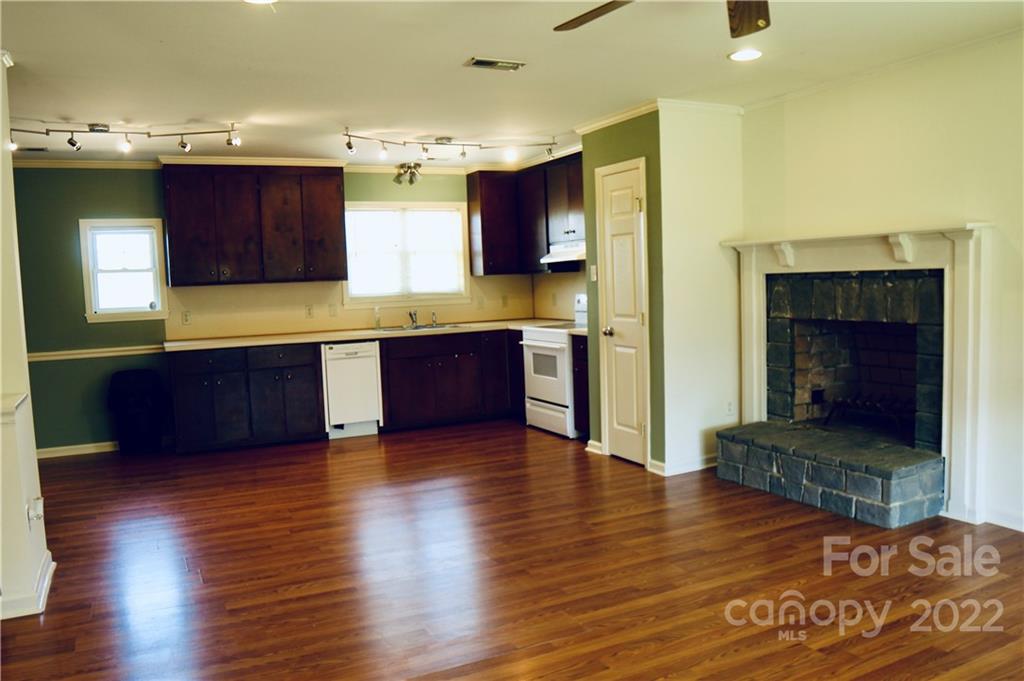 4197 Renee Ford Road Stanfield, NC 28163 - Photo 7 of 23 a large kitchen with wooden floors and stainless steel appliances