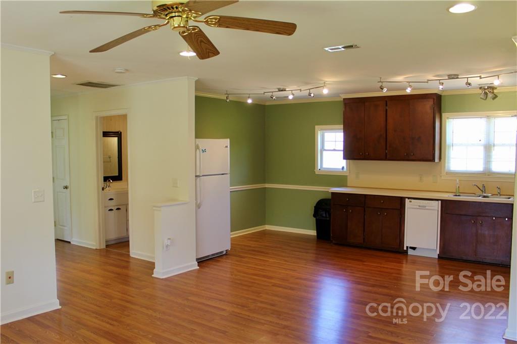 4197 Renee Ford Road Stanfield, NC 28163 - Photo 8 of 23 a kitchen with granite countertop a refrigerator and wooden cabinets