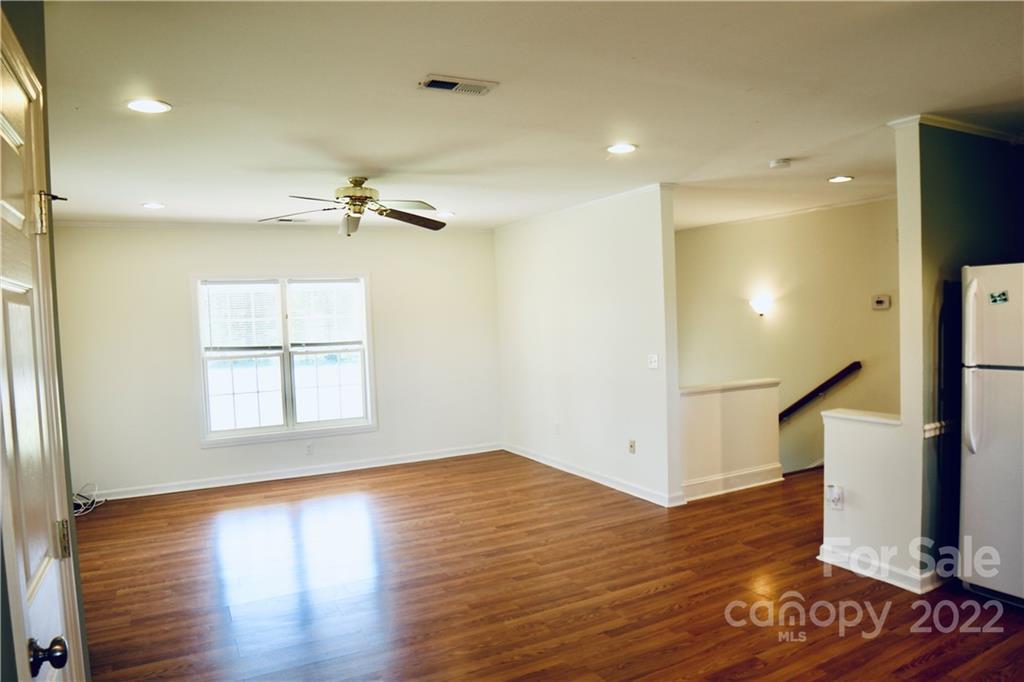 4197 Renee Ford Road Stanfield, NC 28163 - Photo 9 of 23 a view of an empty room with wooden floor and a window