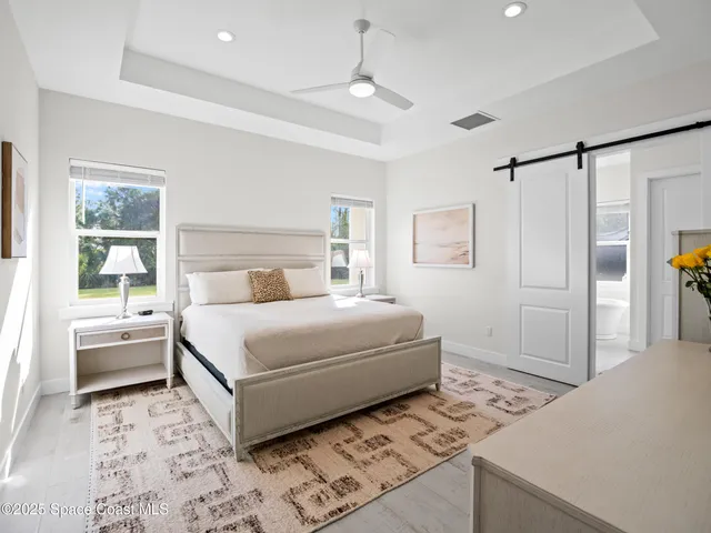 a spacious bathroom with a tub double sink and mirror