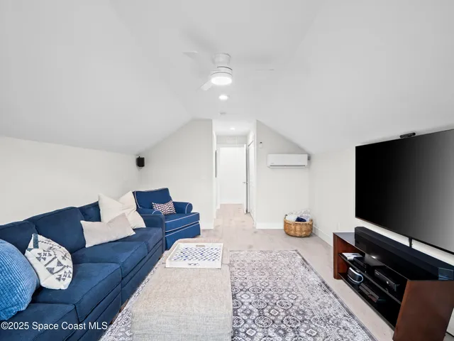 a view of a livingroom with wooden floor and a window