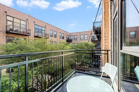 a view of a balcony with chairs