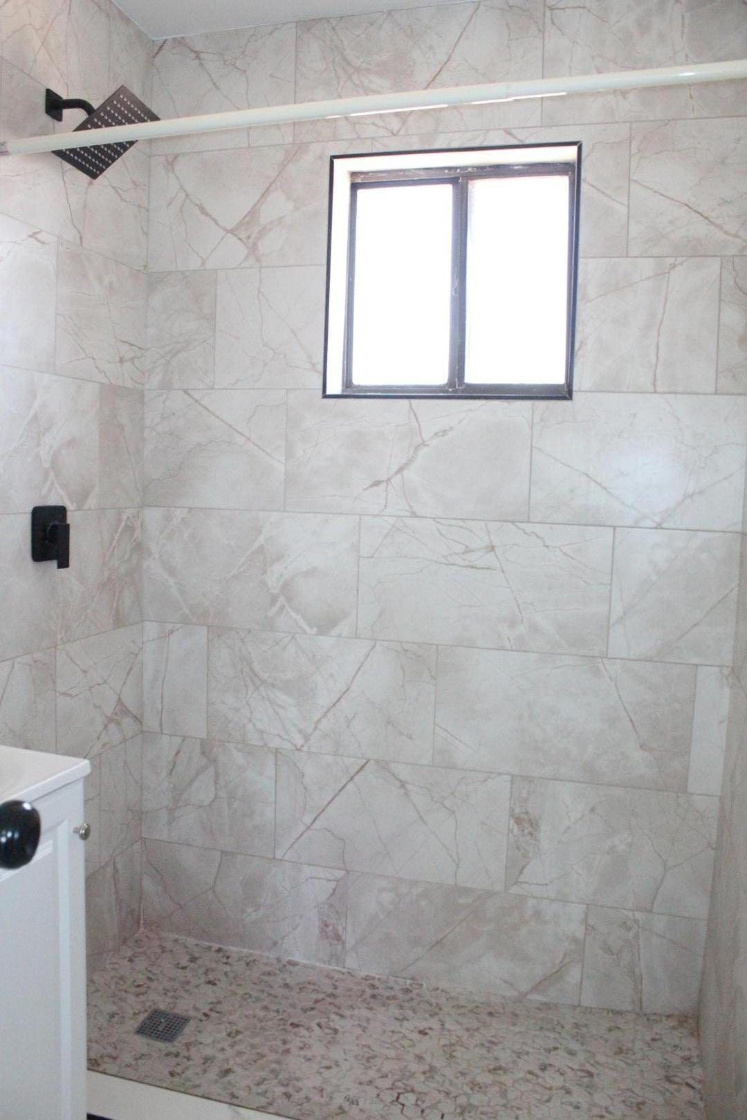 3932 West Griswold Road Phoenix, AZ 85051 - Photo 11 of 20 a bathroom with a window a shower and yard