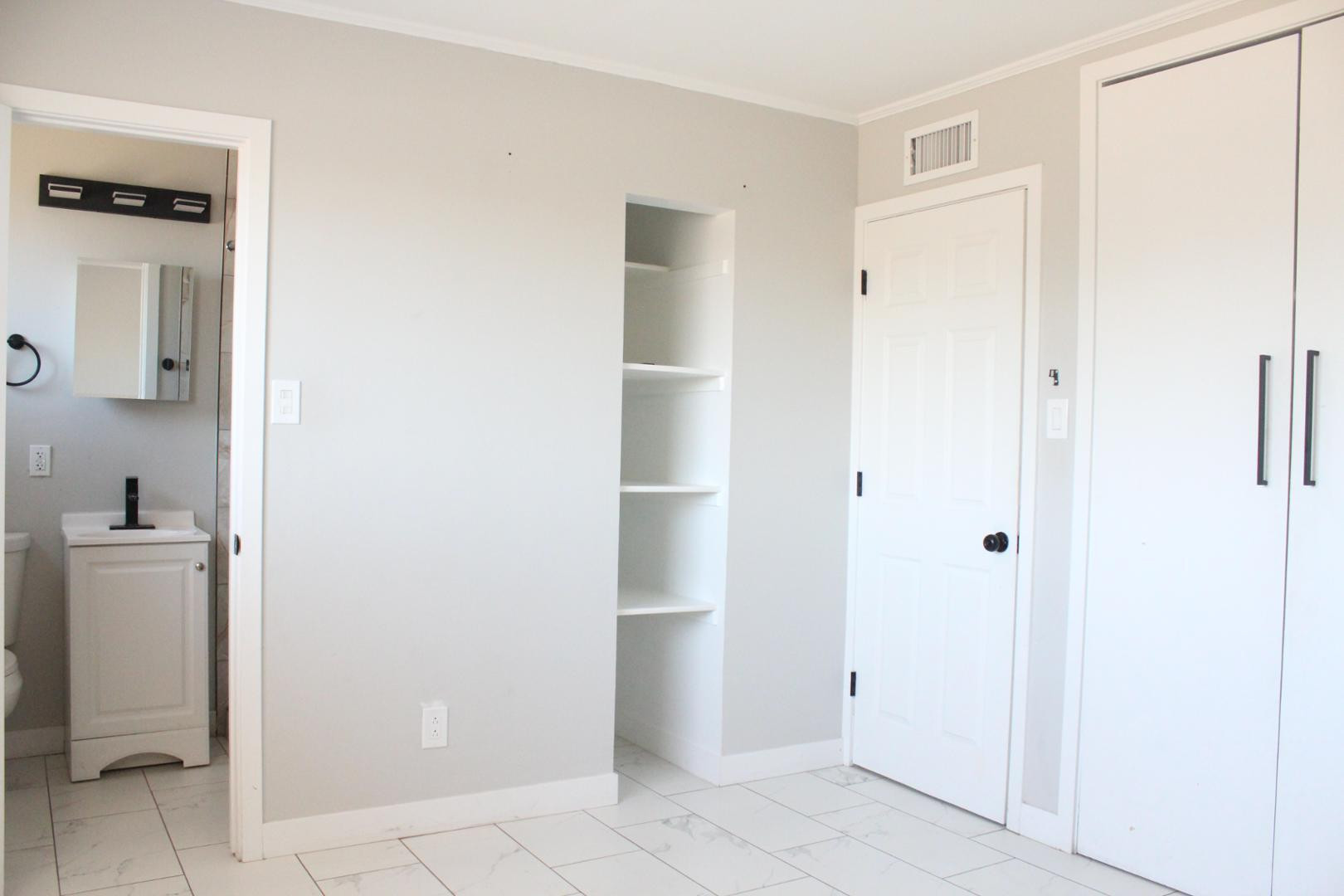 3932 West Griswold Road Phoenix, AZ 85051 - Photo 13 of 20 a view of a hallway with closet and a bathroom