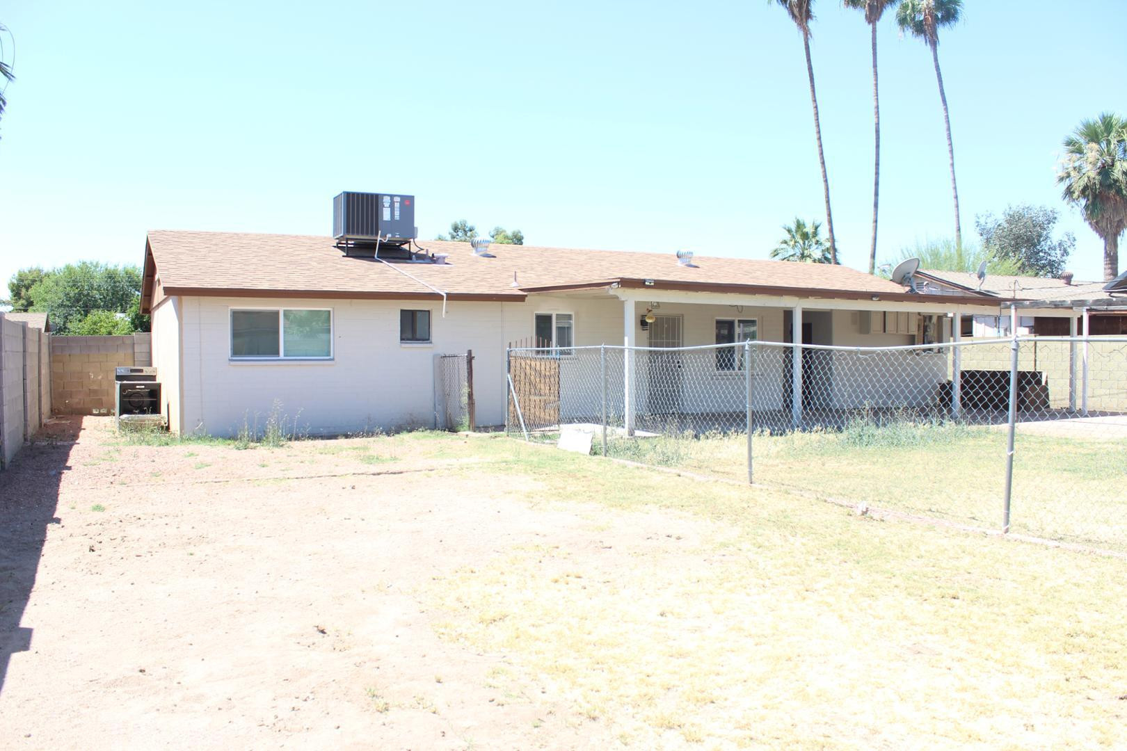 3932 West Griswold Road Phoenix, AZ 85051 - Photo 19 of 20 a view of a house with a swimming pool