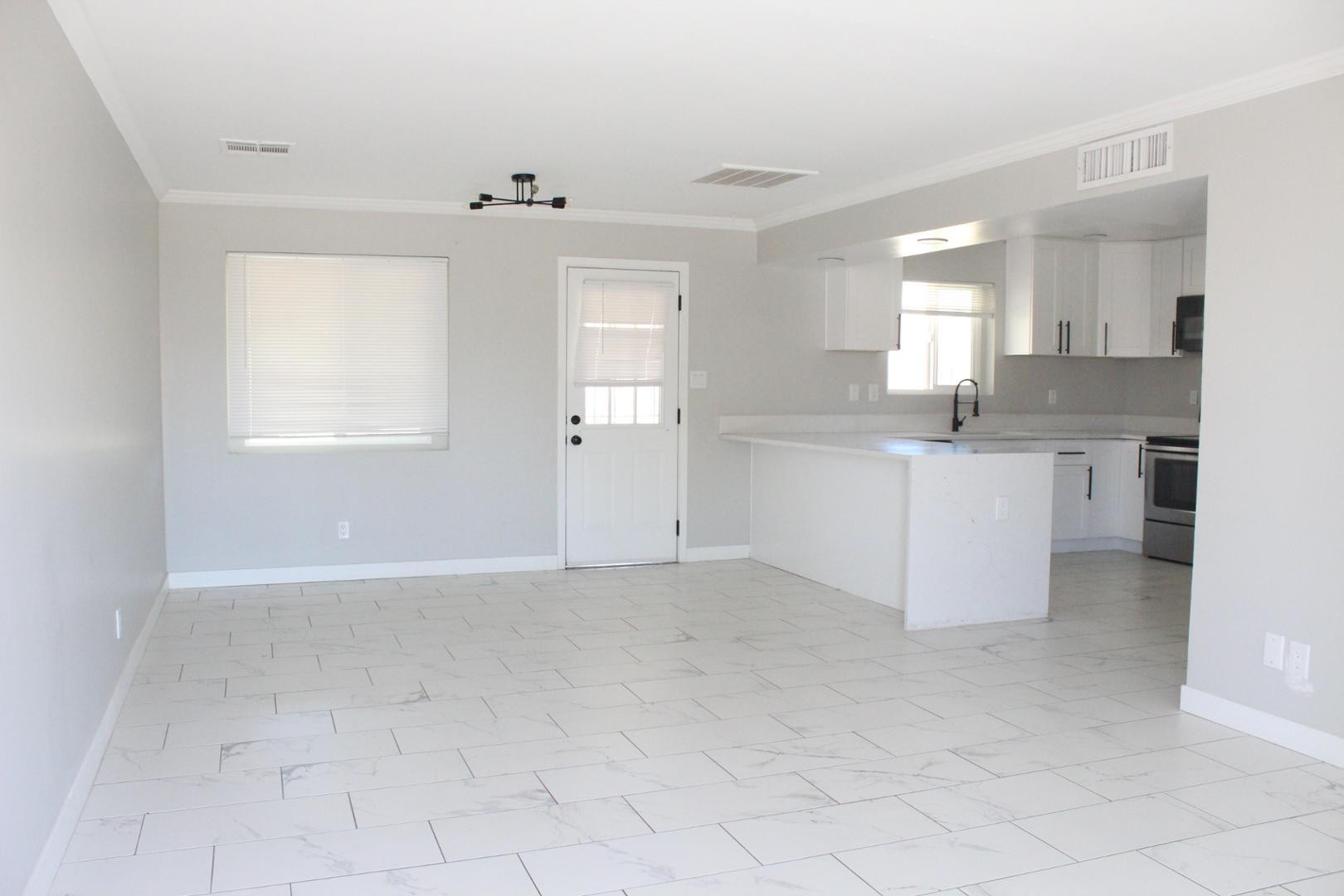 3932 West Griswold Road Phoenix, AZ 85051 - Photo 3 of 20 an empty room with windows and entrance