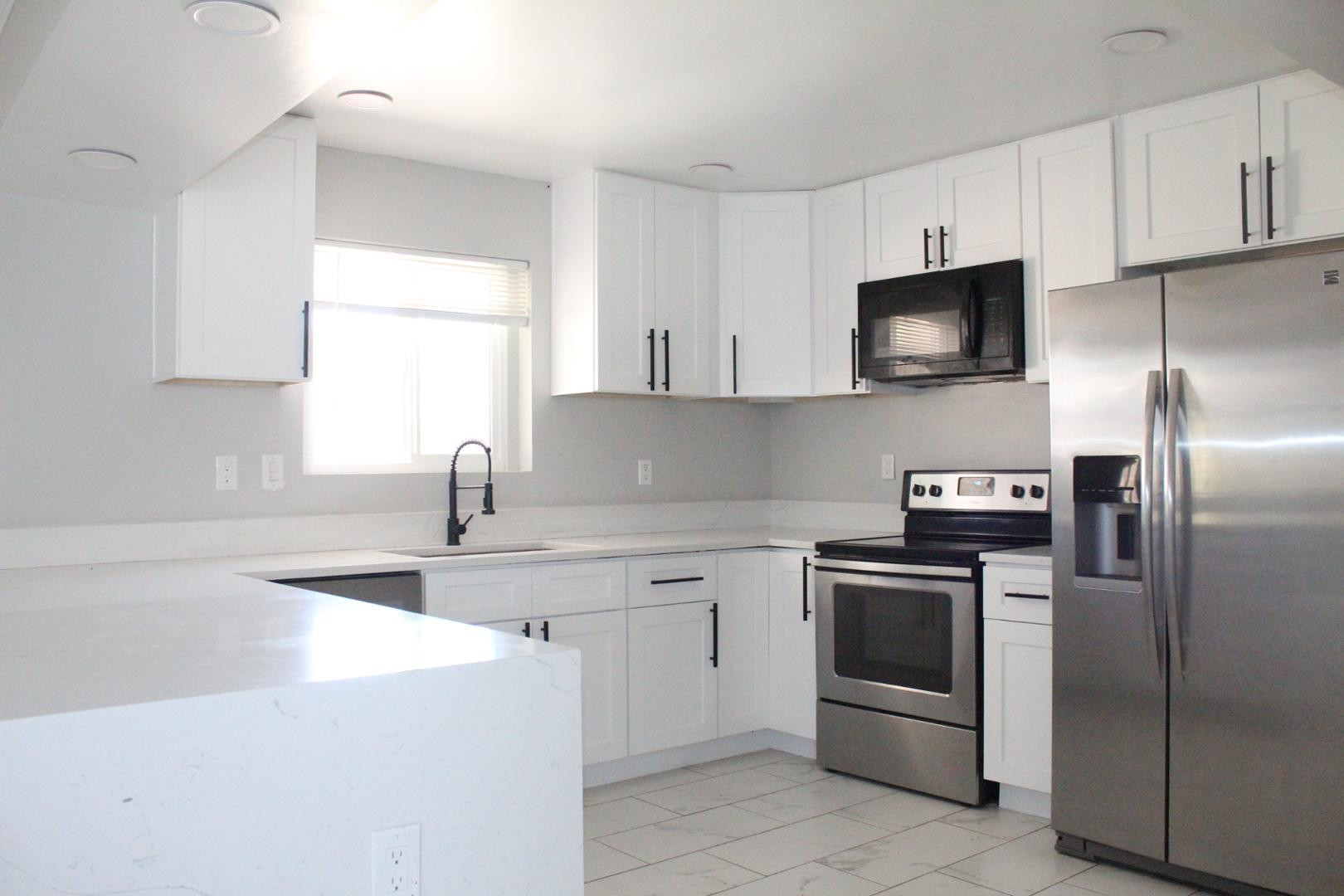 3932 West Griswold Road Phoenix, AZ 85051 - Photo 6 of 20 a kitchen with cabinets stainless steel appliances and a sink