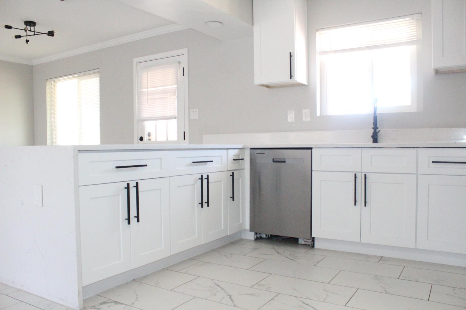 3932 West Griswold Road Phoenix, AZ 85051 - Photo 7 of 20 a kitchen with white cabinets and sink