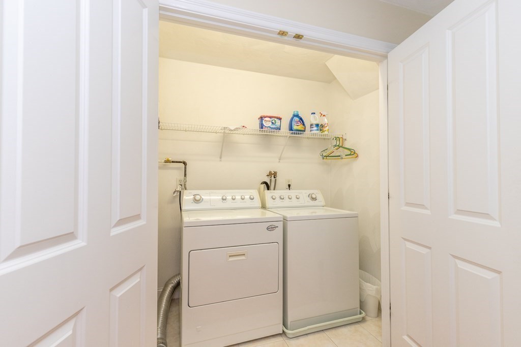 216 Rangeway Road, Unit 161 Billerica, MA 01862 - Photo 20 of 39 a view of washer and dryer with kitchen in the background