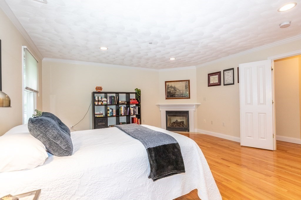 216 Rangeway Road, Unit 161 Billerica, MA 01862 - Photo 21 of 39 a spacious bedroom with a bed and a fireplace